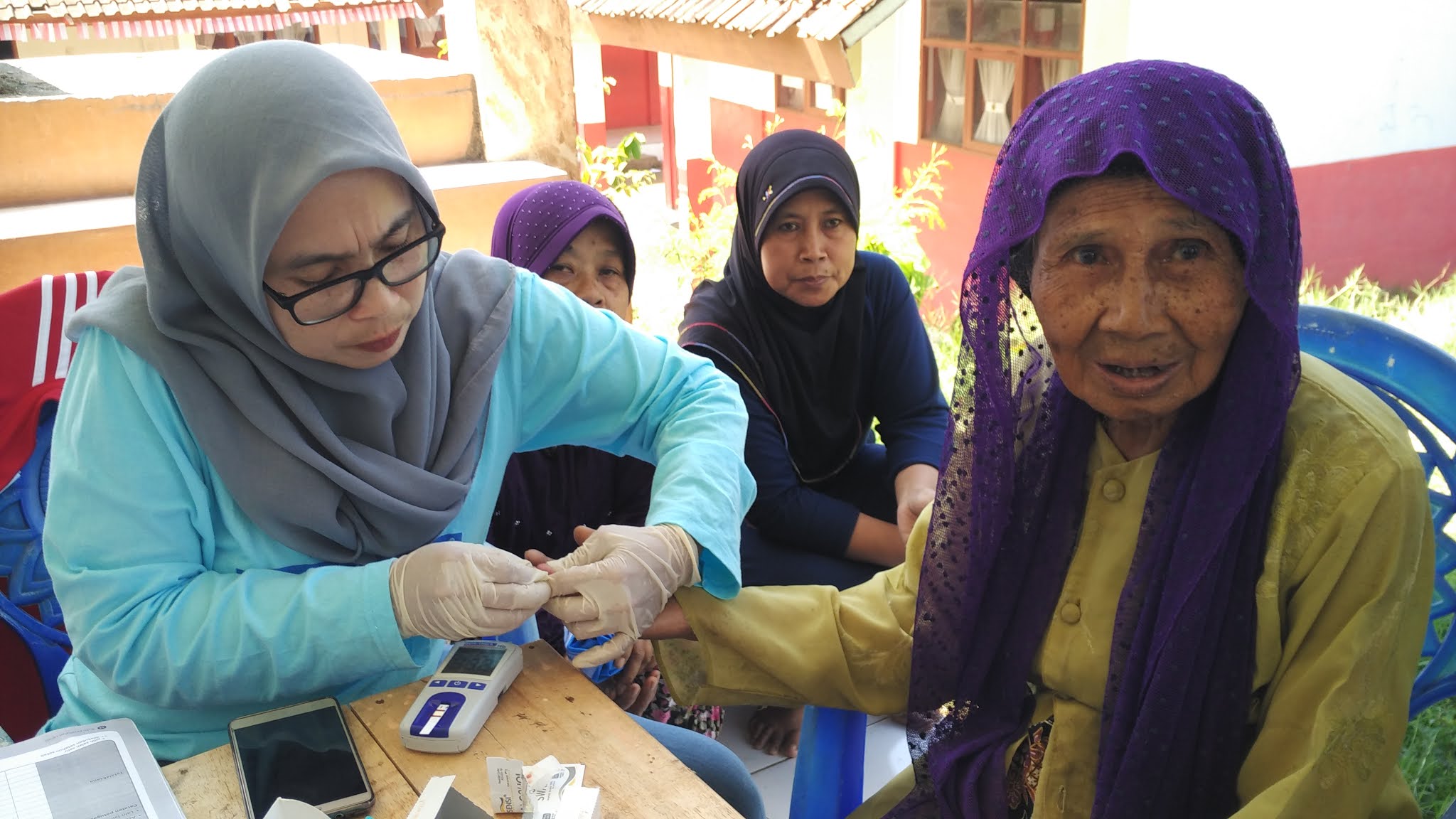 Blood sugar check-up in YUM's Elderly Health Post (“Pre-COVID-19 activities” photo documentation)